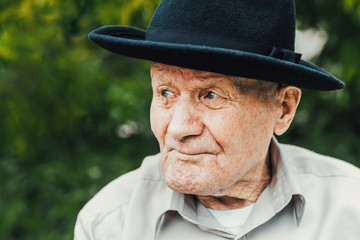 Old senior portrait. Grandparent in hat. 90 plus year. Portrait: aged, elderly, loneliness, man...