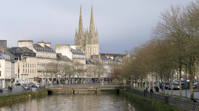 View of the quays of the river that runs through Quimper, a town located in Brittany, in the west of France. There is the cathedral in the background.