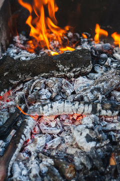 Wood Coals With A Flame In A Mongolian Bbq