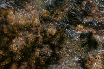 Abstract shallow water top view background, stone bottom underwater
