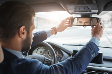 Everything should be perfect. Back view of young and handsome bearded businessman in formal wear...