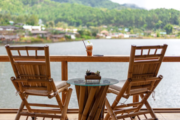 Fototapeta premium The chair in wood terrace against beautiful view relax and happy day, outdoor resort.. Lifestyle Concept
