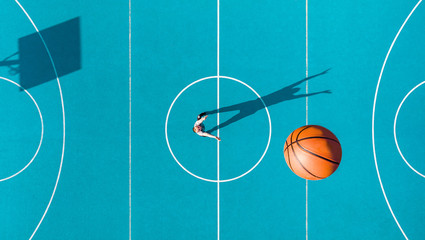 Basketball Player, Long Shadows on Basketball Court, Creative Visual Art, Aerial Image