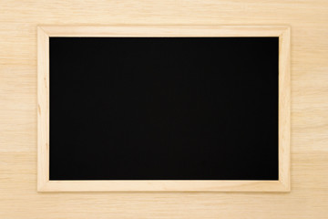 Blank chalkboard on wooden background. 