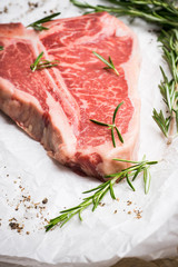 Raw fresh marble T-bone meat on the rustic background. Selective focus. Shallow depth of field.