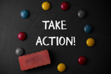Word writing text Take Action. Business photo showcasing do something official or concerted to achieve aim with problem Round Flat shape stones with one eraser stick to old chalk black board