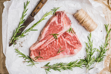Raw fresh marble T-bone meat on the rustic background. Selective focus. Shallow depth of field.