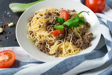 cold pasta in a bowl of tomato and a sprig of celery