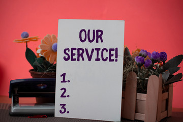 Text sign showing Our Service. Business photo showcasing announcing as repair or provide maintenance for product Flowers and writing equipments plus plain sheet above textured backdrop