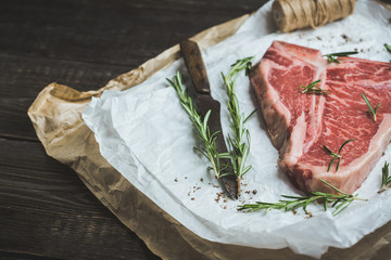 Raw fresh marble T-bone meat on the rustic background. Selective focus. Shallow depth of field.