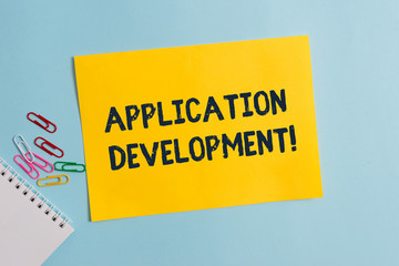Text sign showing Application Development. Business photo showcasing creation of Computer Apps for use on Mobile Devices Plain cardboard and writing equipment placed above pastel colour backdrop