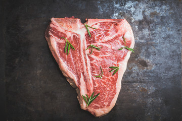 Raw fresh marble T-bone meat on the rustic background. Selective focus. Shallow depth of field.