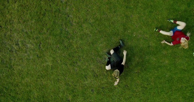 OVERHEAD CRANE Teenage girls football soccer players tackling for the ball. 4K UHD 60 FPS SLOW MOTION