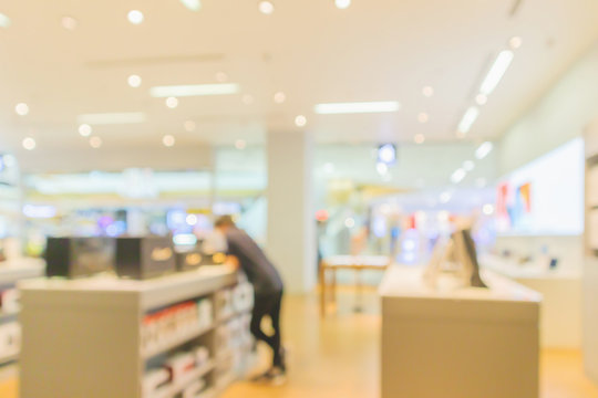 Mobile Phone In Electronic Store Interior With Customer Abstract Blurred Background