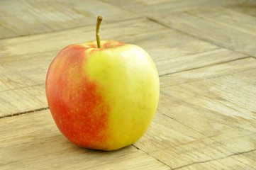 red-yellow apple on a wooden background