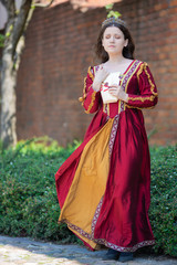 Woman in renaissance dress reading a letter