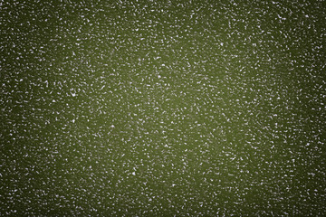 Texture of old green paper background, closeup. Structure of dense cardboard.