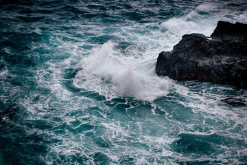 Stormy weather with big waves at rocky coastline of Oahu island, Hawaii.