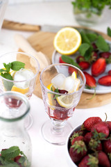 olorful refreshing drinks for summer, cold strawberry lemonade juice in the glasses with ice cubes.