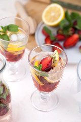 olorful refreshing drinks for summer, cold strawberry lemonade juice in the glasses with ice cubes.