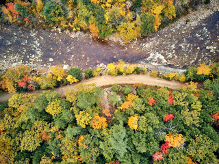 Swift river landscape at autumn in New Hampshire, USA. Fall in New England. Aerial drone shot.