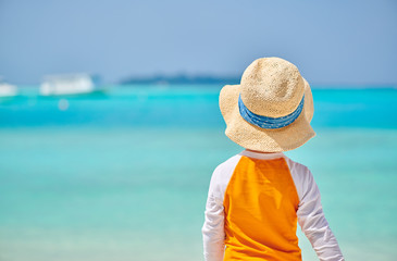 Fototapeta na wymiar Three year old toddler boy on beach. Summer family vacation at Maldives.