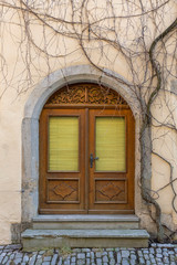 wooden door with a beautiful wooden ornament in the old German town of Rothenburg ob der Tauber