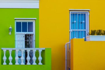 Colorful yellow and green facade of old house in Bo Kaap area, Cape Town
