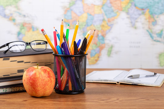 School Teachers Desk With World Map in Background
