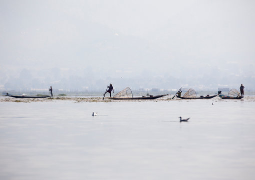 Traditional Fishermen With Fish Trap In Boat, Inle Lake, Myanmar