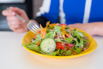 Fresh mixed tuna and vegetable salad in yellow plate