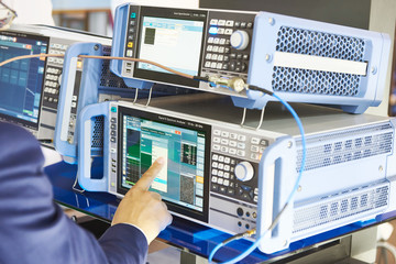 Signal analizer and generator. Man operator hand © Sergey Ryzhov