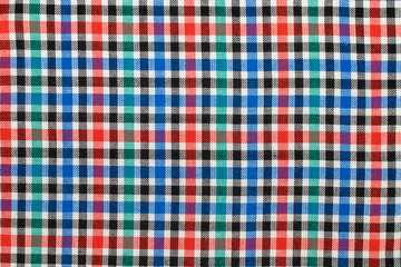 Checkered plaid fabric background. Texture of red blue green plaid fabric cloth
