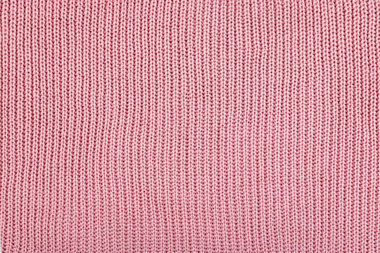 Pink Knitted Fabric background. Knitted woolen fabric rose Texture. Abstract wool sweater texture close up