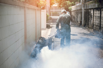 Man work spray fogging, get rid of mosquitoes to stop the spread of dengue fever
