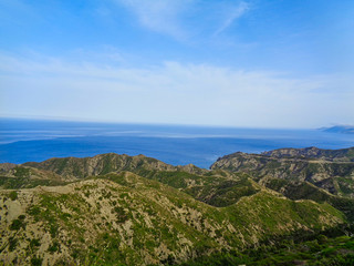 bay in greece with blue ocean and sky at summer