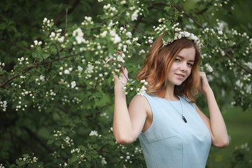 Girl in blue dress in green park