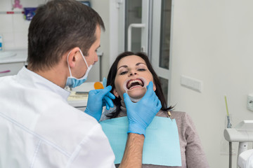 Dentist working with patient in dentist office