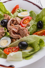 Fresh salad with iceberg lettuce,tomatoes,eggs,canned tuna and olives
