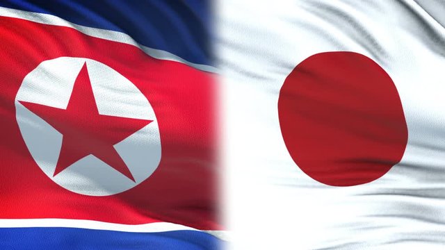 North Korea and Japan officials exchanging confidential envelope, against flags