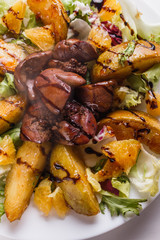 Baked potatoes with boiled chicken liver on a plate