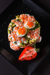 Round salad made of red fish potato and avocado