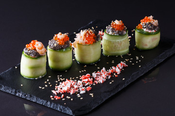 rolls covered in cucumber with caviar and prawn