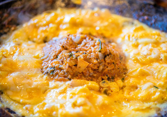 Delicious volcanic shaped fried rice with egg and spicy sauce, pork and squid, famous south korean food in jeju island restaurant, close up