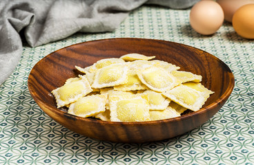 Homemade ravioli on rustic background