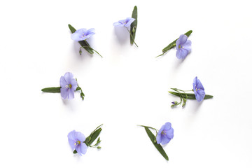 decorative flowers and leaves of lavender are arranged in a circle on the white background top view. summer frame with copy space