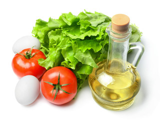 Salad, eggs, tomatoes and vegetable oil. White isolated background. Bright saturated colors. Top side view.