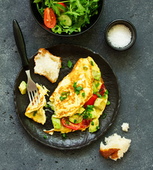 omelet with avocado, tomatoes and cheese for breakfast.