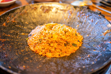 Delicious volcanic shaped fried rice with egg and spicy sauce, pork and squid, famous south korean food in jeju island restaurant, close up