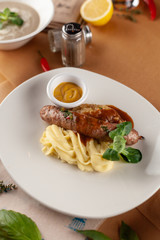 Bratwurst with mashed potato, gravy and mustard